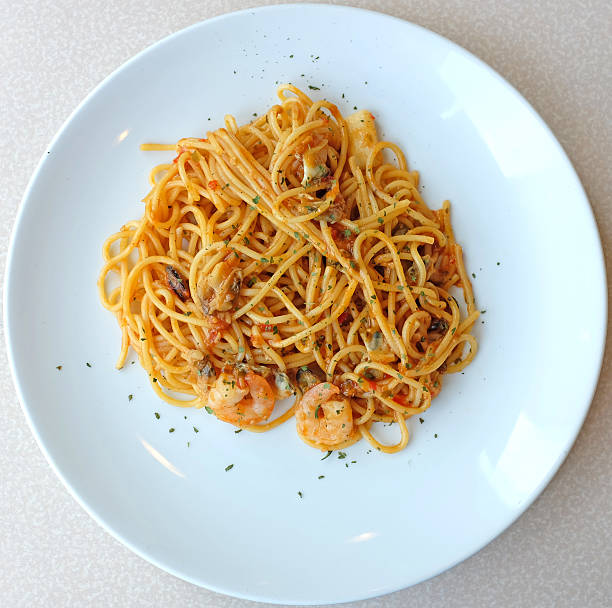 istock Delicious pasta spaghetti with shrimps in white plate 546020902