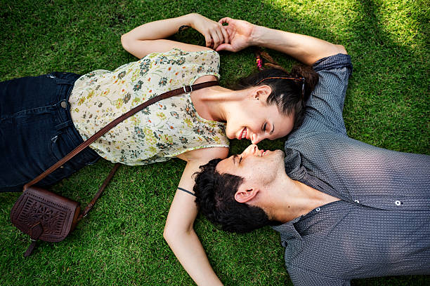 istock Sweet Couple Laying Grass Concept 546023800