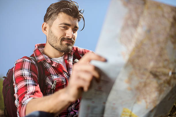 istock Young traveler looking at the map 546025964