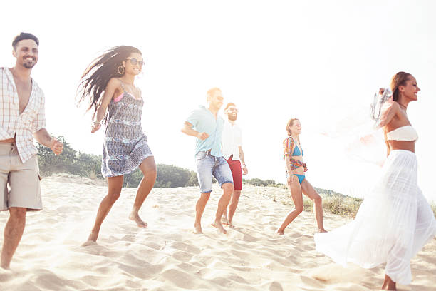 istock Group of young people having fun on the beach 546026472