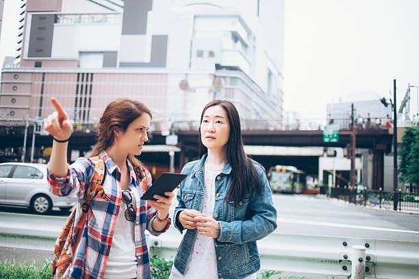 istock Young woman asking for direction on street 546026984