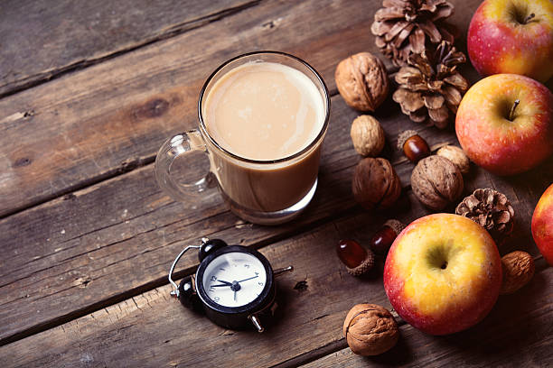 istock apples, fir-cones, cup of coffee, clock and nuts 546162658