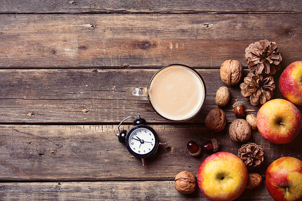 istock apples, fir-cones, cup of coffee, clock and nuts 546162832