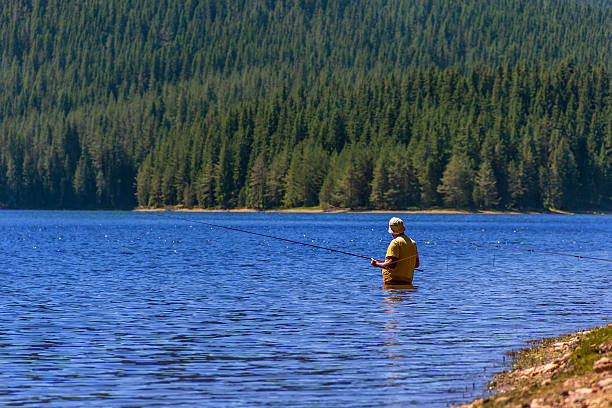 istock Fisherman fishing on a lake 546164524