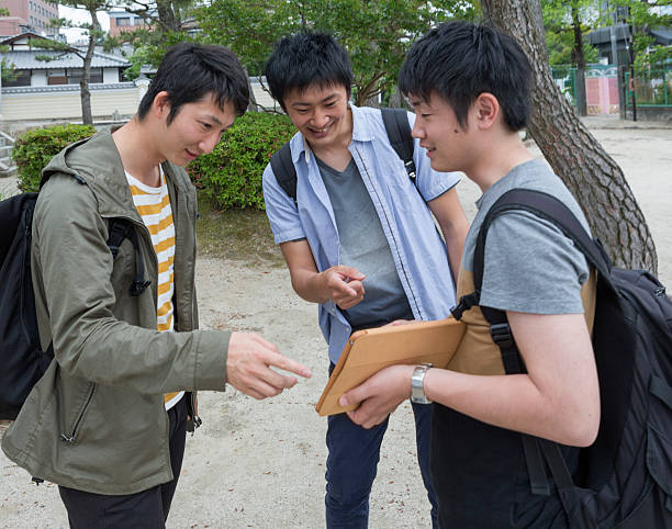 istock japanese students together with classmates checking notepad in kyoto japan 546164654