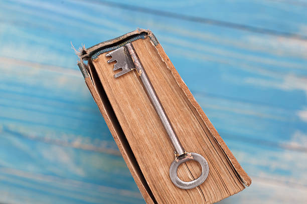 istock Vintage book with old grunge paper and rusty key 546166014