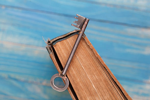 istock Vintage book with old grunge paper and rusty key 546167400