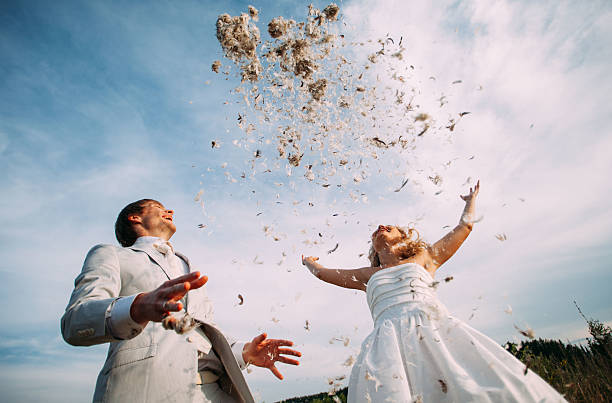 istock bride and groom are fighting pillows outdoor 546167830