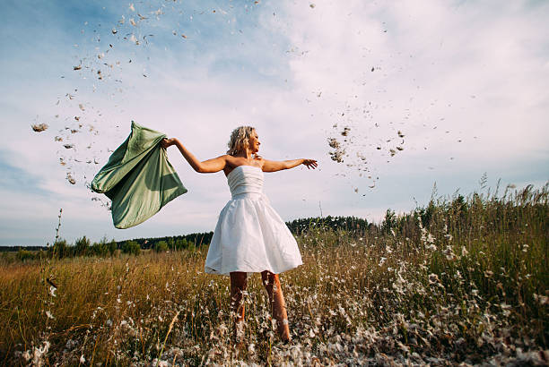 istock bride and groom are fighting pillows outdoor 546167898