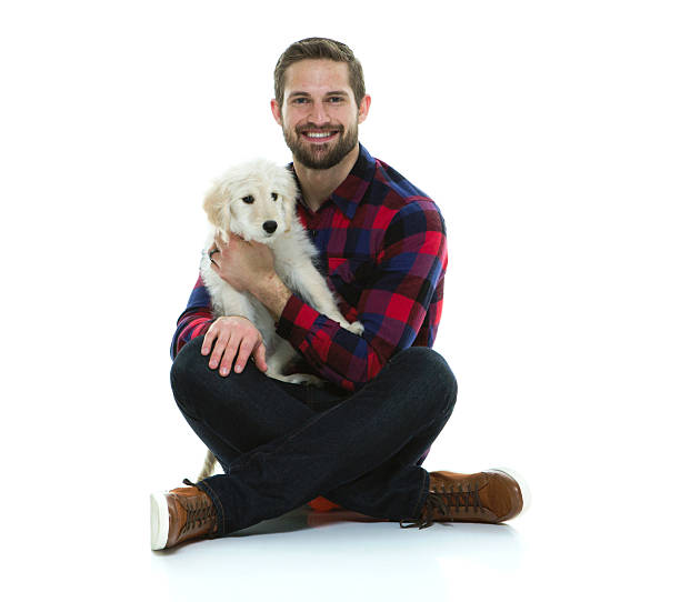 istock Smiling man sitting with his dog 546168194
