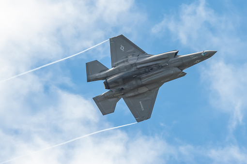 Farnborough, Hampshire, UK - July 5, 2016: Low level aerobatics during a validation flight by a Lockheed Martin F-35B Lightning II in the skies over Farnborough, Hampshire, UK prior to public air display performances.