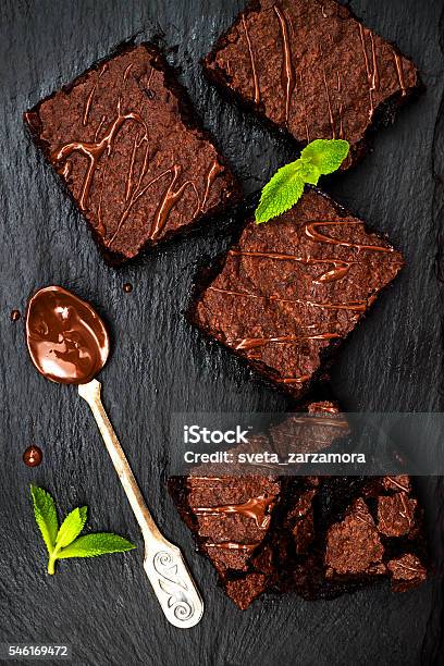 Homemade Dark Chocolate Brownies Decorated With Strawberries And Mint Leaves Stock Photo - Download Image Now