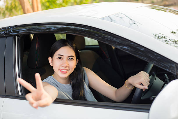 istock Cute young lady happy driving car 546169510