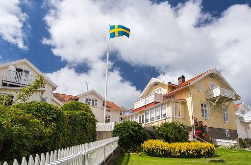 At the village of Lysekil on the West coast of Sweden, numerous wooden houses sit on the hilltop to face the North Sea horizon. The Swedish flag is always raised too. In Sweden, wood is the primary material used for building housings.