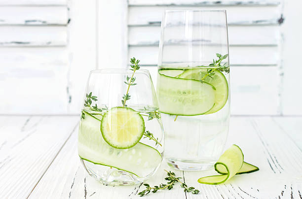 Cucumber infused hydrating water with thyme and lime stock photo