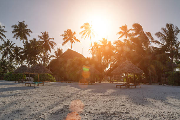 Pongwe Bay, Zanzibar, Tanzania - December 29, 2013: Sunset with low tide and tourist resort in background - Zanzibar
