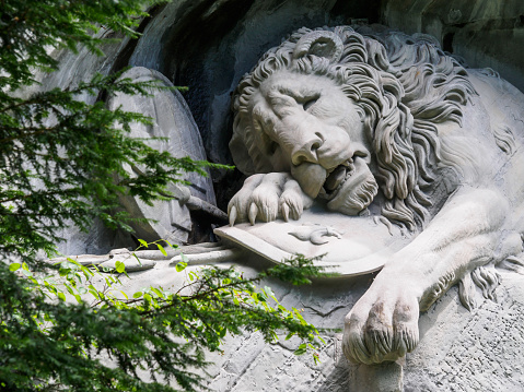 Lewendenkmal, the lion monument landmark in Lucerne, Switzerland. It was carved on the cliff to honor the Swiss Guards of Louis XVI of France.Lewendenkmal, the lion monument landmark in Lucerne, Switzerland. It was carved on the cliff to honor the Swiss Guards of Louis XVI of France.
