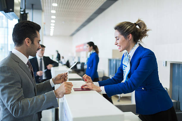 Business man in check-in counter with boarding pass. Business man in check-in counter with boarding pass. check in person stock pictures, royalty-free photos & images