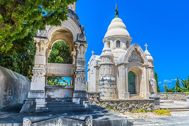 Local cemetery entrance Supetar. Old cemetery in town Supetar, Island of Brac, view at entrance building exterior made with traditional architecture style. Selective focus. old catholic church on island brac croatia stock pictures, royalty-free photos & images