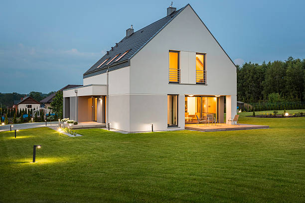 New house ideal for family Big light house in new design with wide lawn and outdoor lighting, night view landscape lighting stock pictures, royalty-free photos & images