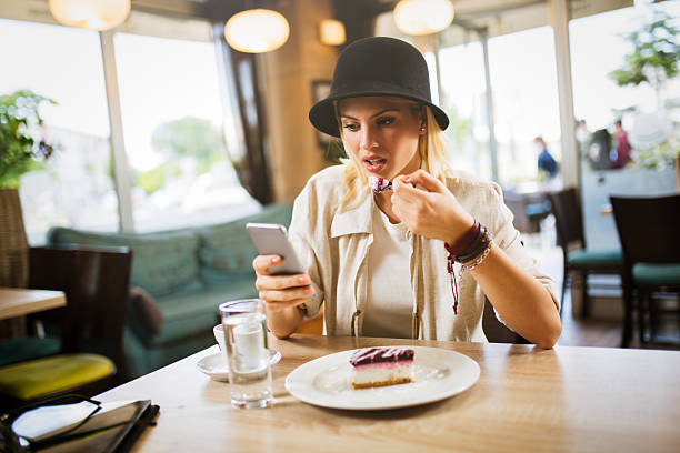 istock Attractive young businesswoman using mobile phone in modern cafe. 546176716