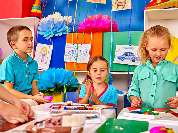 istock Group kids mold from plasticine in kindergarten . 546177294