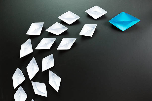 istock Leadership concept illustrated with paper ships 546177330