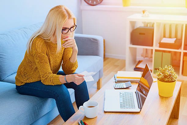 istock Worried young woman counting bills 546178346