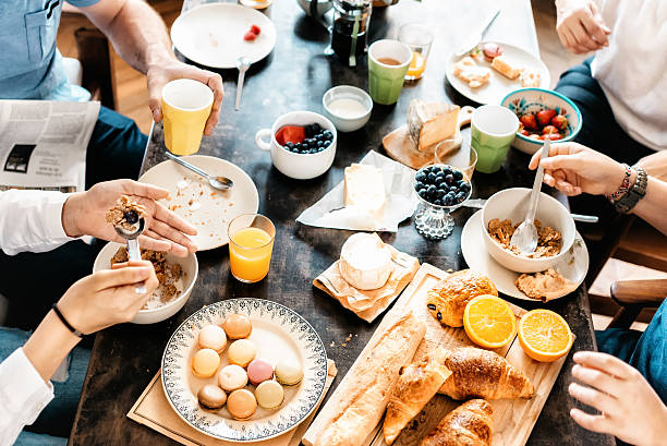 週末に一緒に朝食をとっている家族 - dining table people foods and drinks restaurant ストックフォトと画像