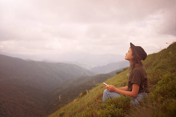 istock Woman using smartphone in mountains 546182658