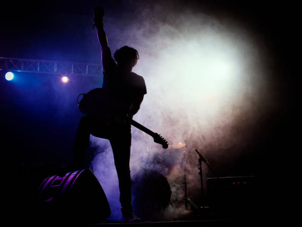 istock Silhouette of guitar player on stage. 546183820