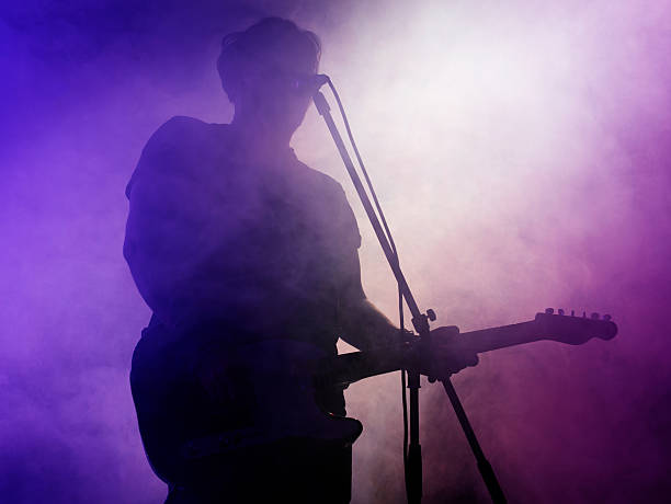 istock Silhouette of guitar player on stage. 546183960