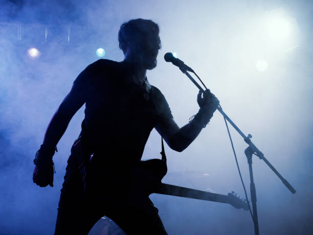 istock Silhouette of guitar player on stage. 546184120