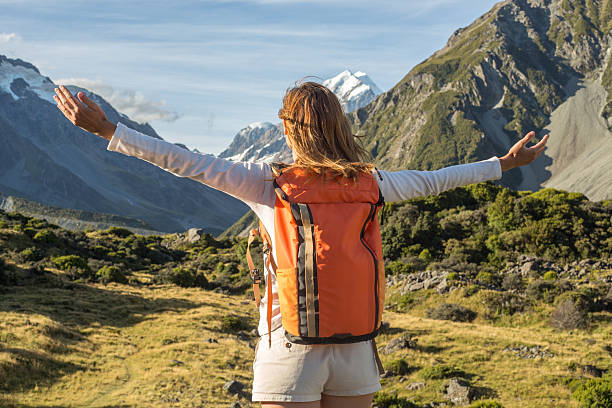 istock Hiker stands on mountain arms outstretched, Mount Cook on background 546184458