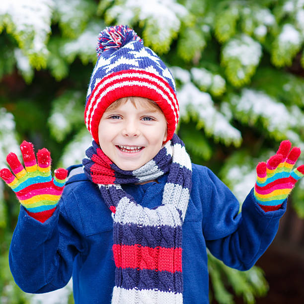 istock Happy kid boy having fun with snow in winter 546185778