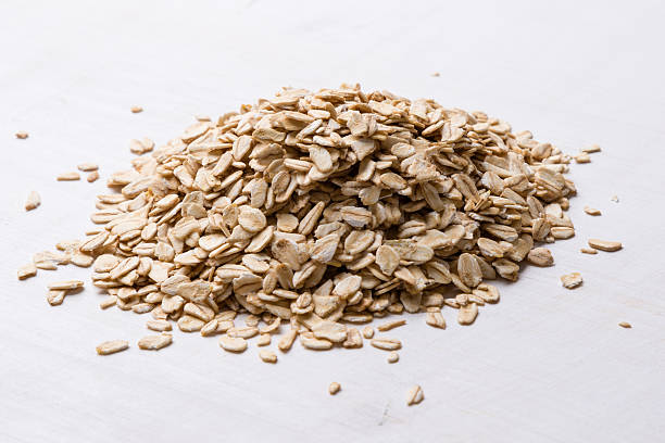 oat flakes on white table stock photo