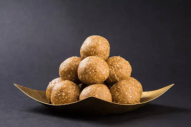 indian sesame sweet or tilgul laddu, made up of jaggery and sesame seeds, hand made, round, indian sweet prepared in Makar Sankranti