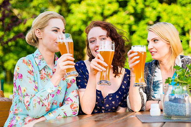 istock Friends drinking beer in garden pub having fun 546185974