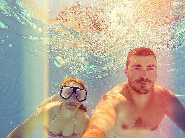 istock Couple having fun under the water 546186122