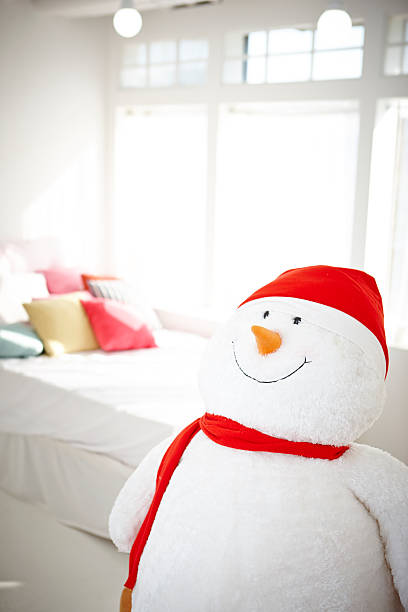 Beautiful snowman near colored New Year 's Eve girleans. New Years symbol