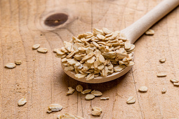 istock oat flakes with wooden spoon 546186454