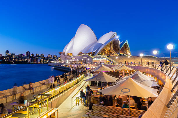 cafe with people and the sydney opera house at twilight - sydney opera house sydney australia australia opera house imagens e fotografias de stock