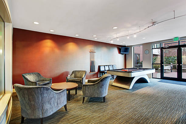 istock Basement room interior with comfortable chairs and biliards 546188864