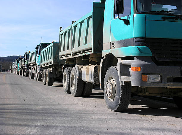 istock Trucks on road building 546189210