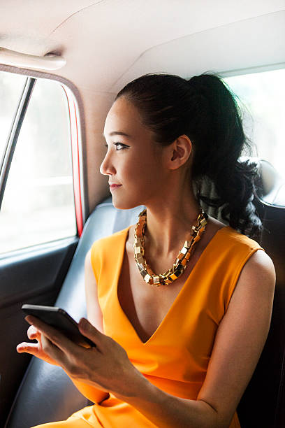 istock Young Asian Girl Planning Her Schedule While On A Ride 546191290