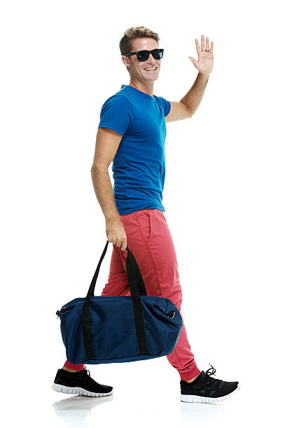 istock Smiling casual man waving hand and walking 546193004