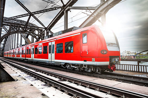 Passenger Train passing on a bridge in Frankfurt, Germany Passenger Train passing on a bridge in Frankfurt, Germany. train vehicle stock pictures, royalty-free photos & images