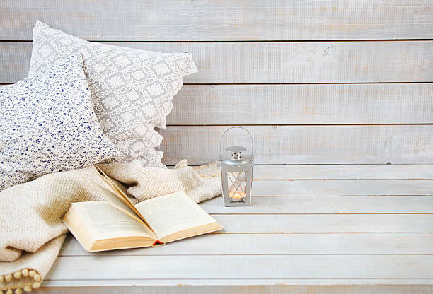 istock Cozy still life with lantern, pillows, book and plaid 546194044