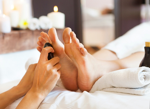 Massage of human feet in spa salon