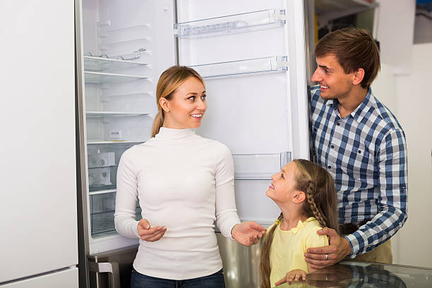 family selecting refrigerator - three different refrigerators imagens e fotografias de stock
